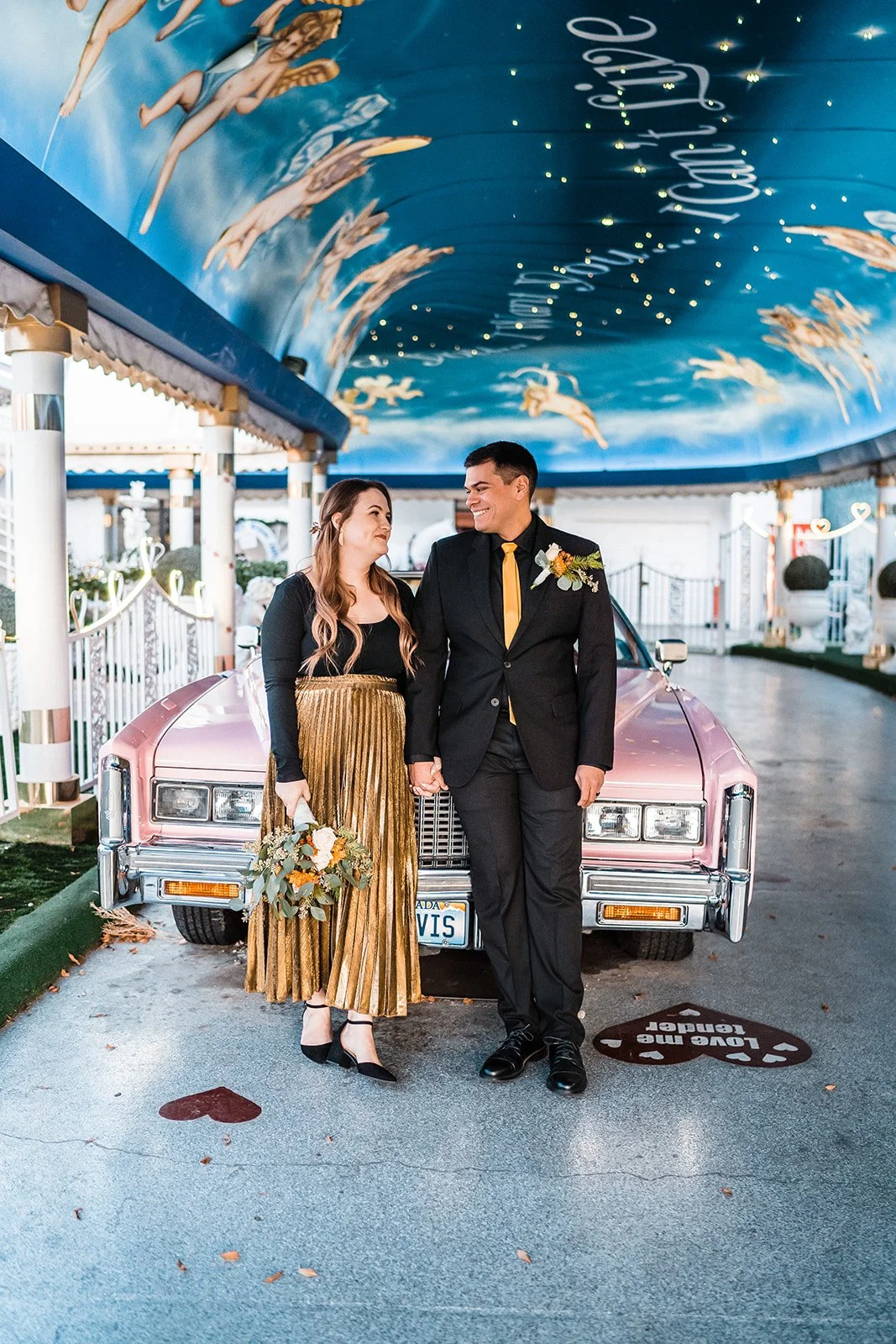 Couple after their Pink Cadillac Elopement at The Little White Wedding Chapel in Las Vegas, Nevada.