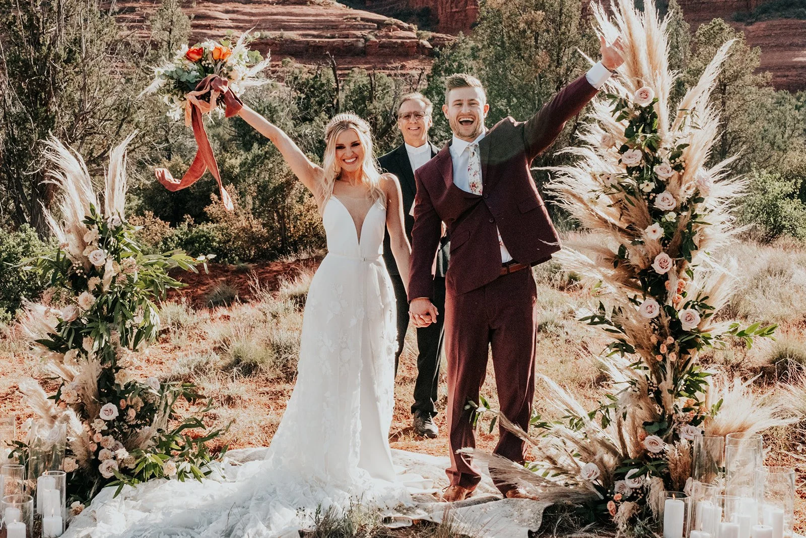 Couple cheering after eloping at cathedral rock in Sedona, Arizona.